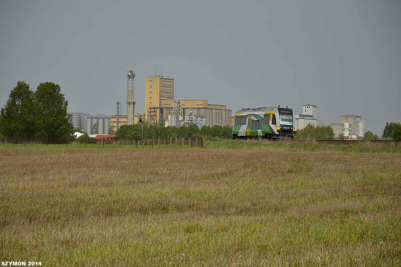 Autobus szynowy SA135-015 spki Koleje Mazowieckie opuci stacj Sierpc i mija sierpecki browar, pocig osobowy 51344 relacji Sierpc - Kutno, 7.05.2014 r.
